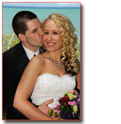 Groom kisses his new bride on the cheek