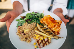 The wedding caterer displays a meal he prepared for the reception