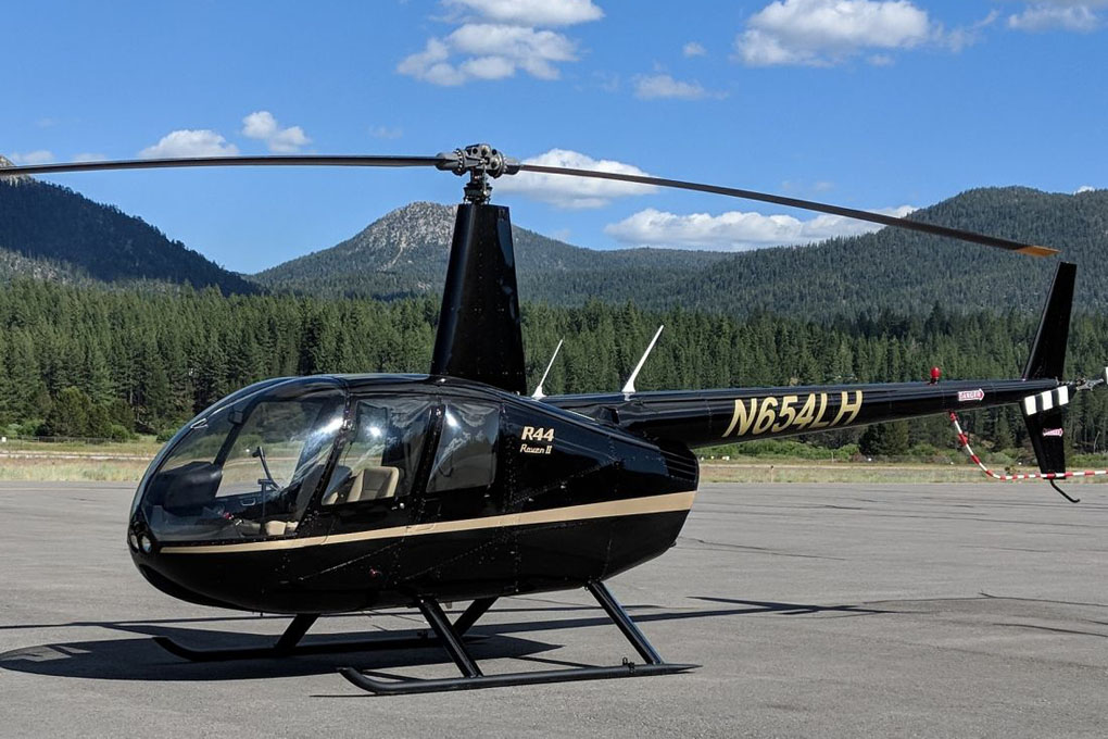 Black helicopter parked on the tarmac.