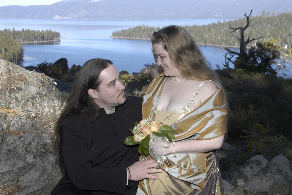 Bride smiles affectionately at her groom with Emerald Bay in the backdrop.