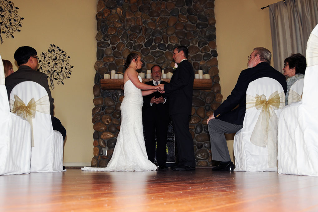 Bride and groom in the indoor chapel exchanging their marriage vows.