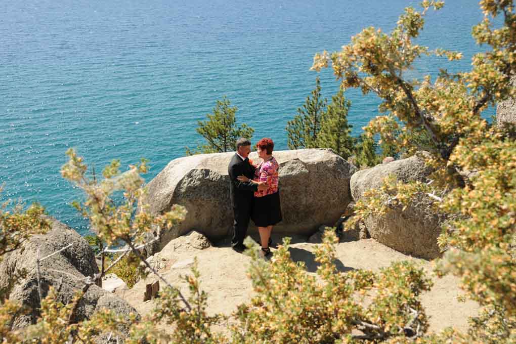 Bride and groom facing each other on the nook of the vista.