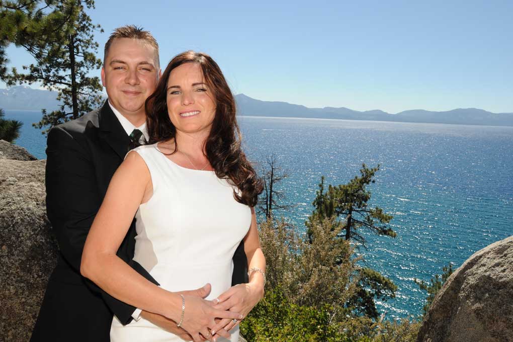 Happy couple smiles happily at the bluff edge of Logan Shoals.