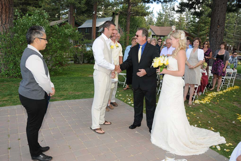 Father shakes groom's hand after giving his daughter to him.