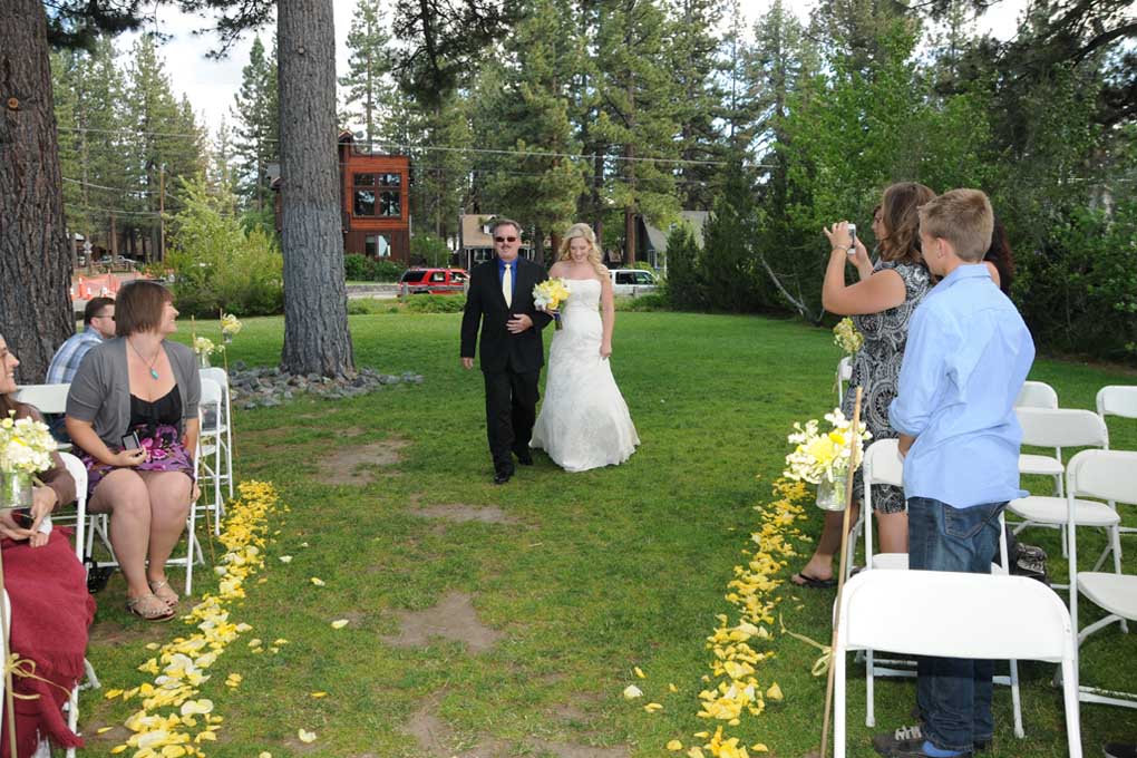 Father walking the bride down the aisle during the processional.