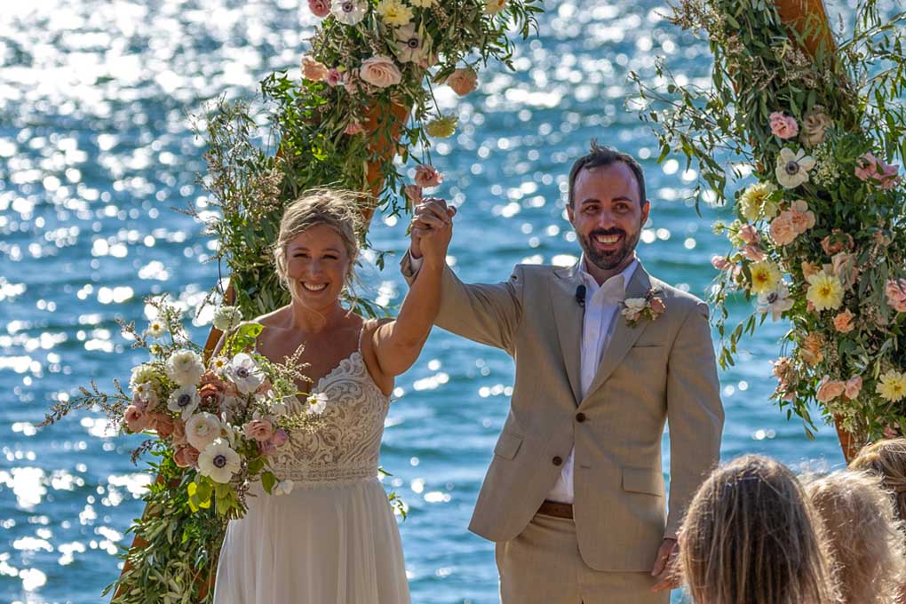 The pair hold their hands high in celebration after being married.