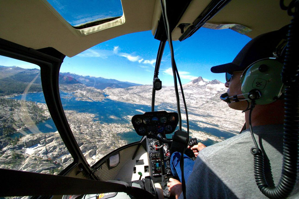 Helicopter pilot flying over Lake Tahoe.