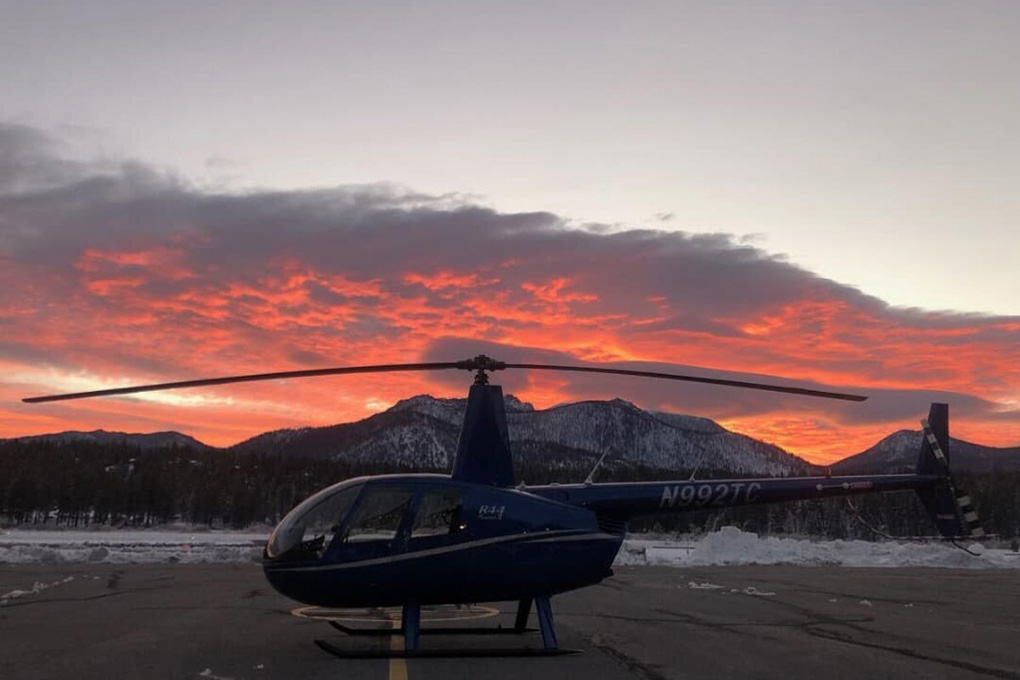 Helicopter on the tarmac at sunset.