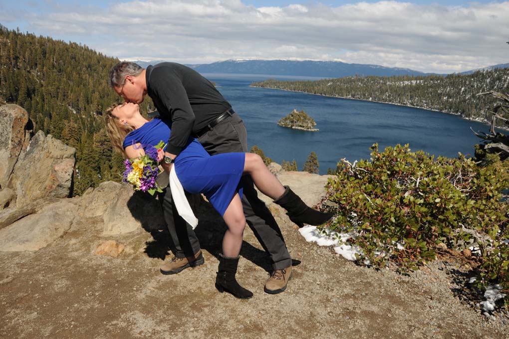 Groom leaning his bride backward.