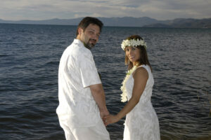 Twosome by lake looking back to smile at camera.