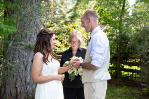 Groom slides wedding ring on his bride's finger during the service.