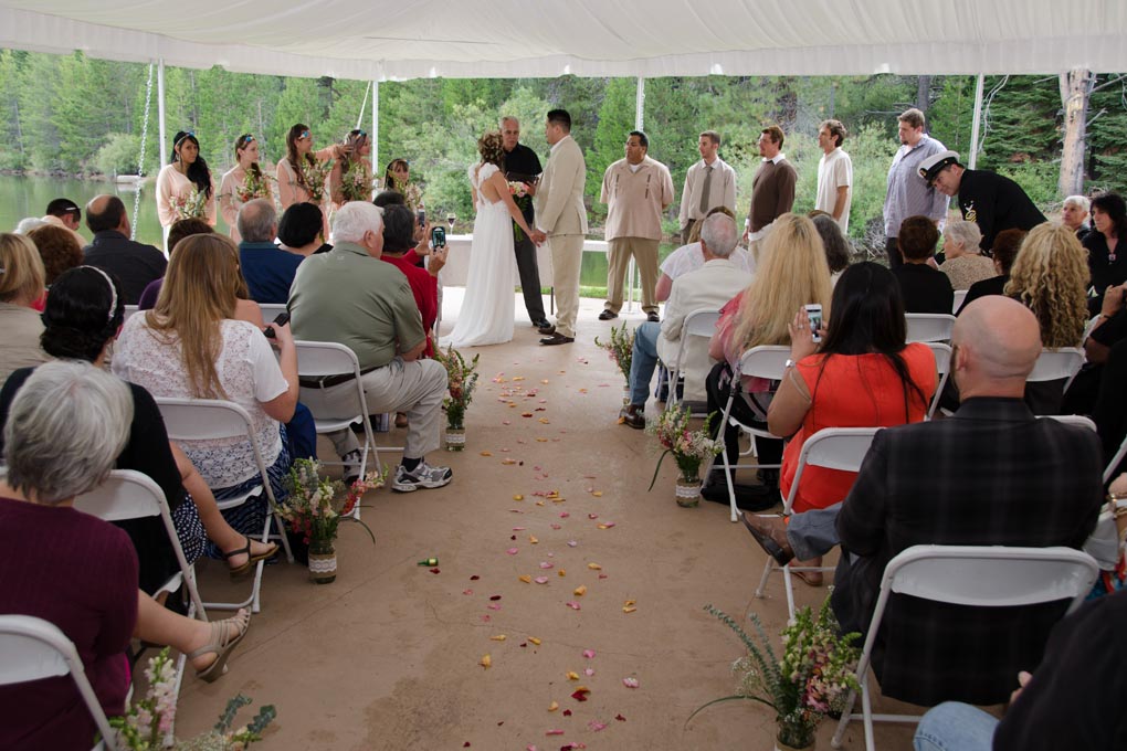 Wedding ceremony taking place under the canopy.