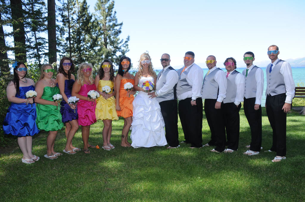Entire bridal party posing together wearing decorative eye glasses.