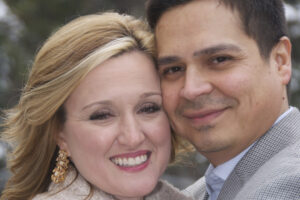 Newly married pose with cheeks together.