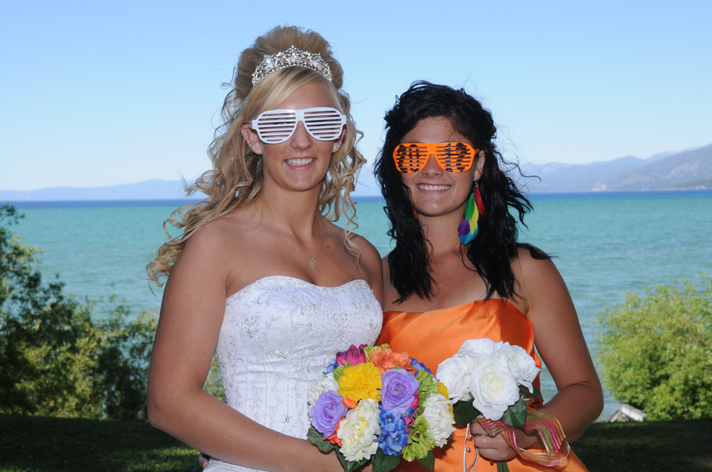 Bride and bridesmaid wearing funny eye glasses.