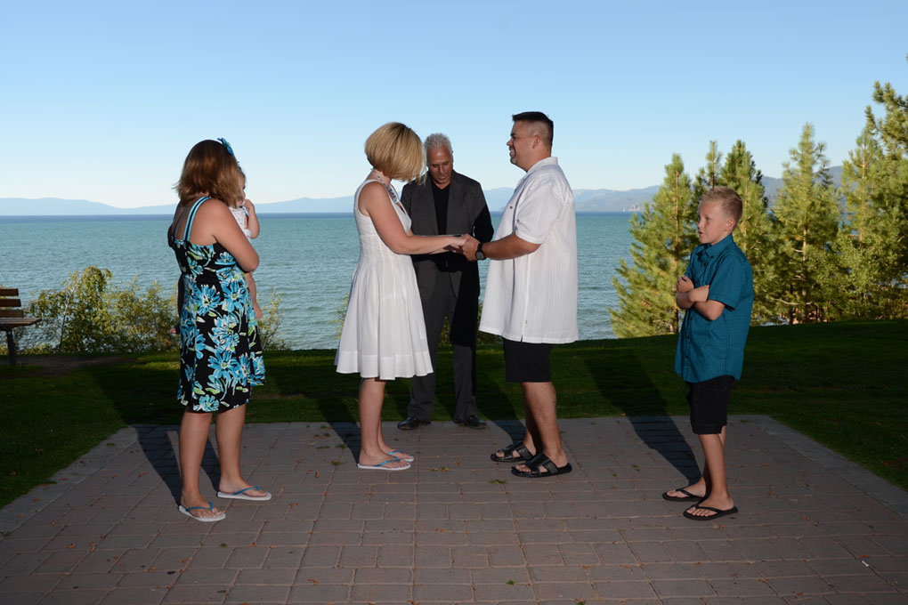 Bride and groom stand before the minister during their wedding service.