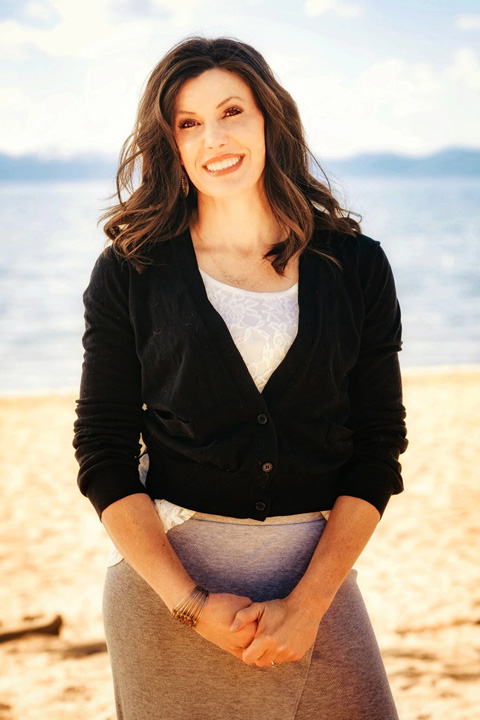 Reverend Tawni posing on the beach.