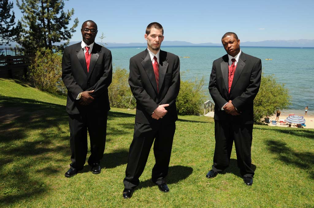 Groomsmen pose with a serious facial expression.