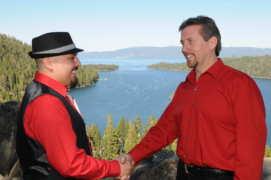 Best man congratulates the groom with a hand shake.