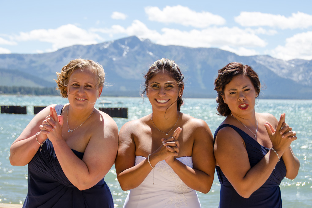 Bride and her bridesmaids having fun making hand signs.