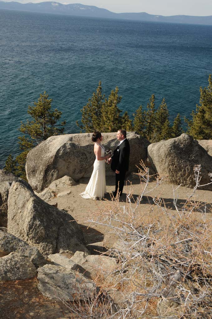 Bride and groom facing each other near the overlook of Logan Shoals.