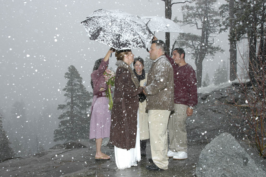 Wedding ceremony continues as the snow falls.
