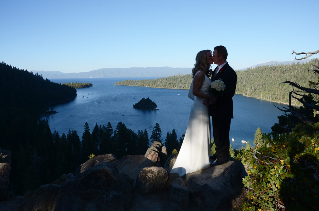 Silhouette of a married couple on the precipice of Emerald Bay.