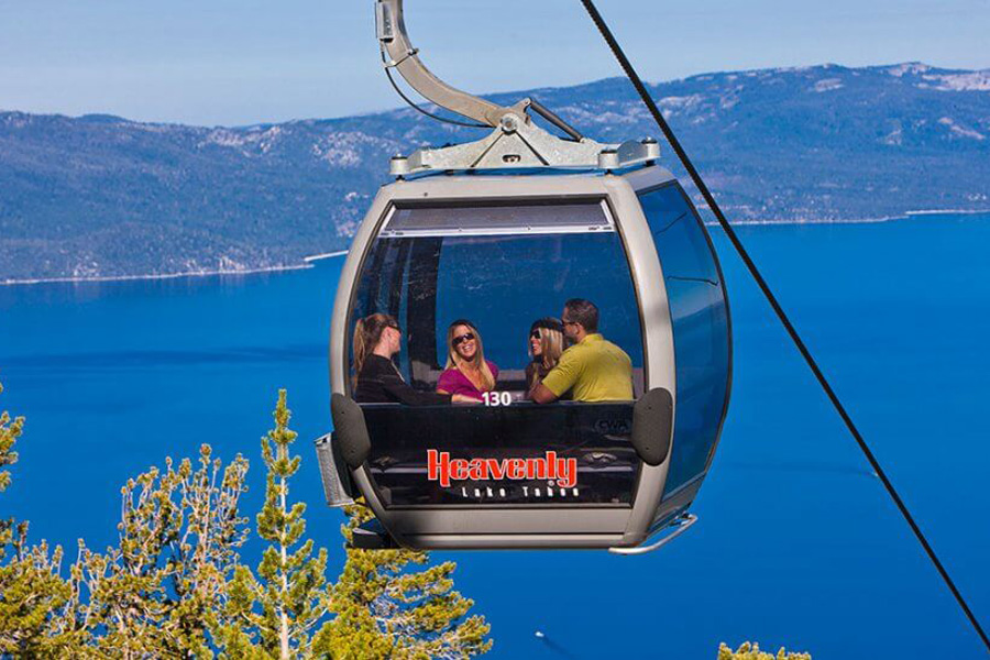 Gondola car suspended in the air overlooking Lake Tahoe.