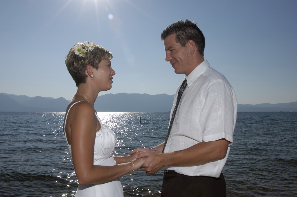 Beautiful lake background with couple in the foreground holding hands.