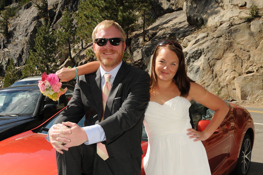 After being pronounced husband and wife, the couple pose by their car together.