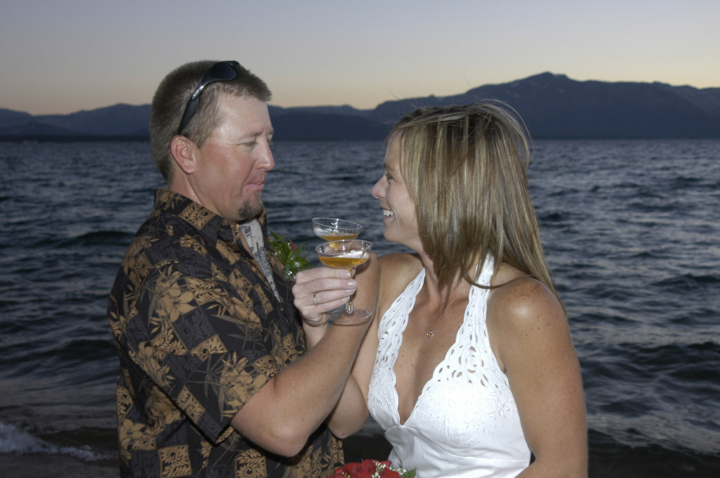 Bride and groom celebrating their unity with intertwined arms and champagne glasses.